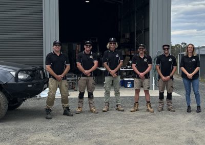 A vertical photo of the the Sea 2 Sky Electrical Team standing outside the Jindabyne workshop - local Jindabyne electricians